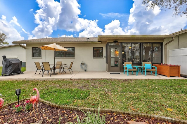 11430 94th St, Largo, FL 33773 - rear view of property featuring a lawn, stucco siding, fence, and a patio