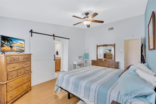 11430 94th St, Largo, FL 33773 - bedroom with light wood-type flooring, a barn door, visible vents, and a ceiling fan