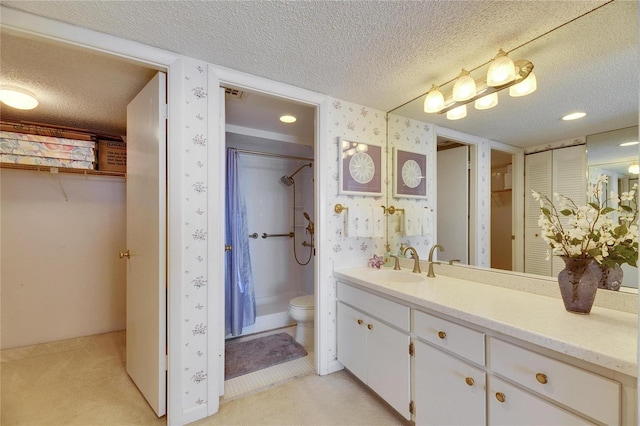 full bath featuring a textured ceiling, toilet, vanity, walk in shower, and wallpapered walls