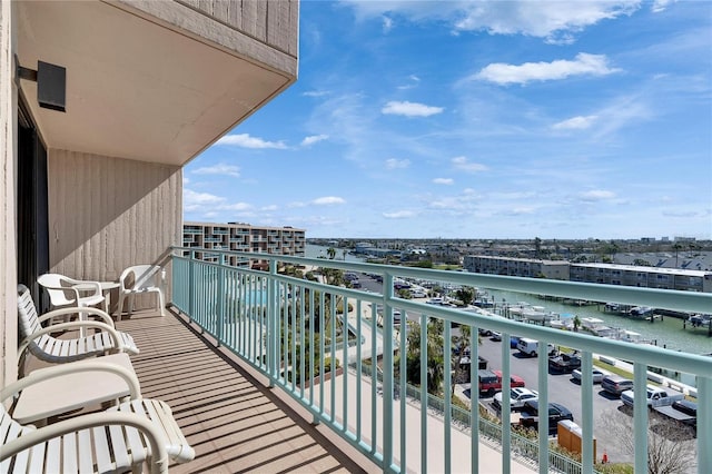 balcony with a view of city and a water view