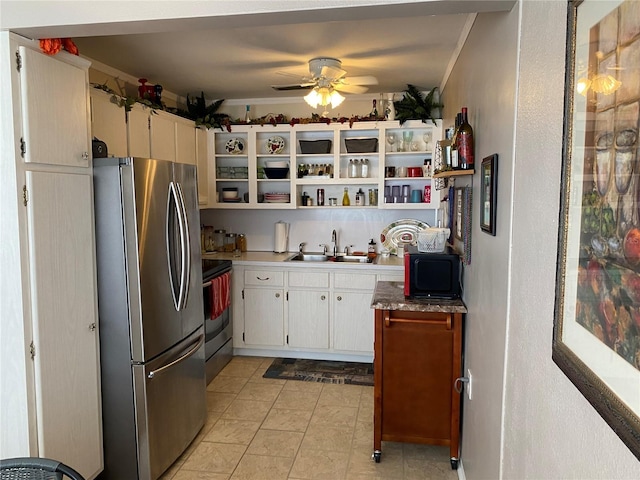 kitchen with a ceiling fan, stainless steel appliances, crown molding, open shelves, and a sink