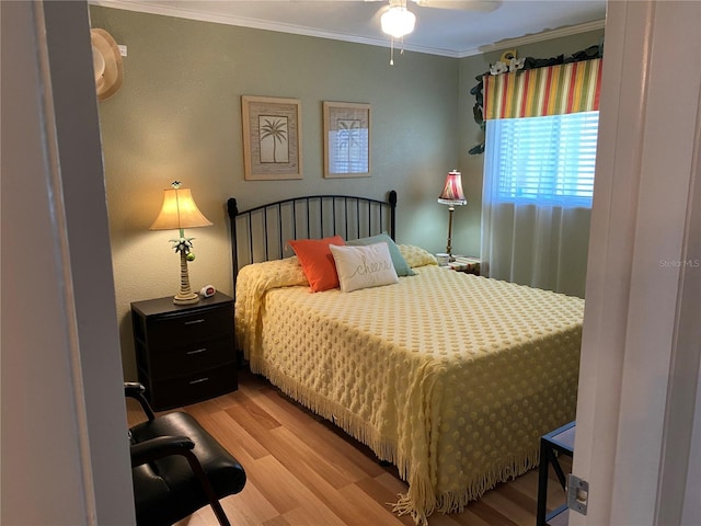 bedroom featuring crown molding and wood finished floors