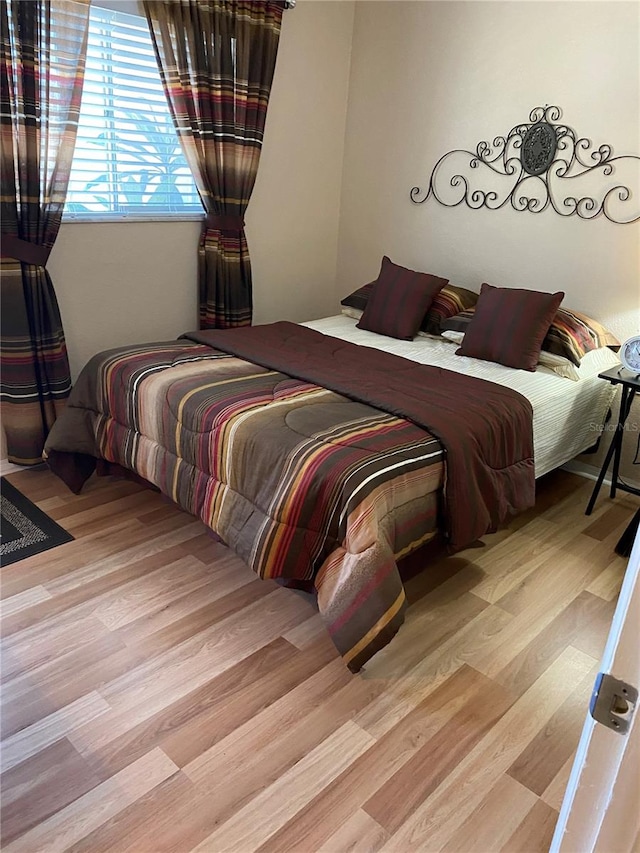 bedroom with wood finished floors