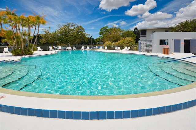 pool with fence and a patio