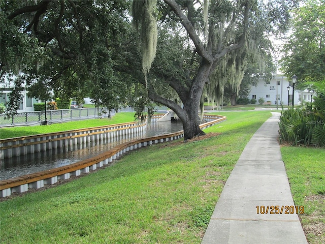 view of yard featuring a water view and fence