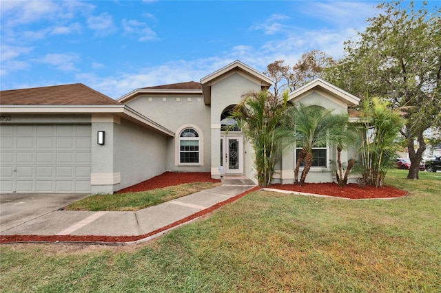 view of front of home with a garage, a front yard, and stucco siding