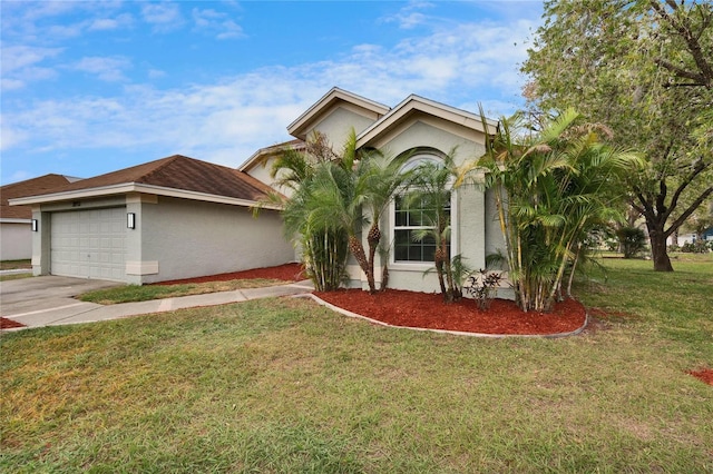 view of front of house featuring an attached garage, a front lawn, concrete driveway, and stucco siding