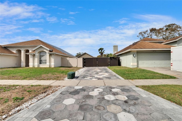 view of front of house featuring a front yard, a gate, and stucco siding