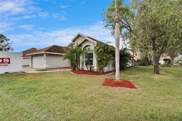 view of front of home featuring a garage, driveway, and a front yard