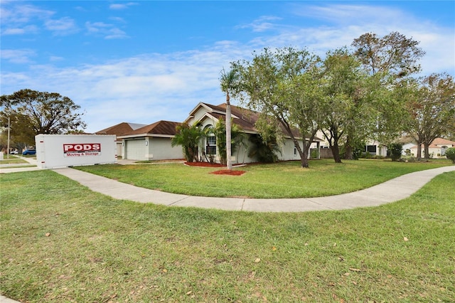 ranch-style home with a garage, stucco siding, and a front yard