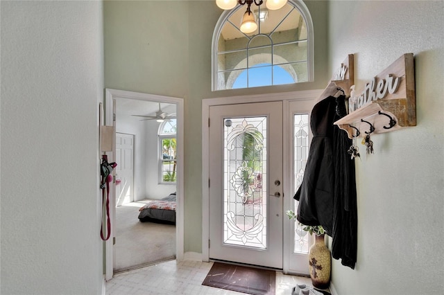 foyer with a towering ceiling and a chandelier