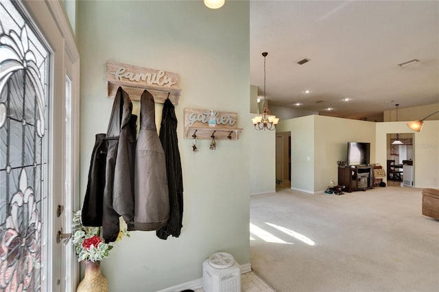 mudroom with carpet floors, baseboards, and an inviting chandelier