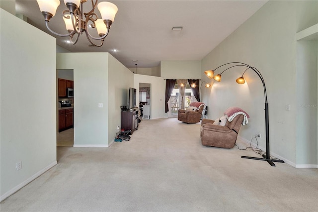 sitting room featuring a chandelier, light colored carpet, and baseboards