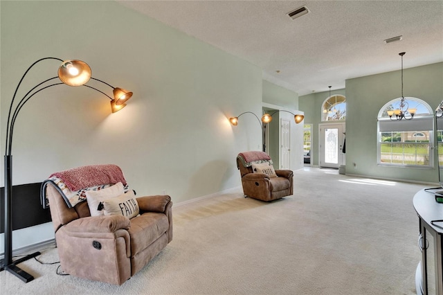 sitting room featuring an inviting chandelier, baseboards, visible vents, and carpet flooring