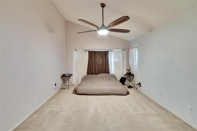 bedroom with carpet floors, baseboards, vaulted ceiling, and a ceiling fan