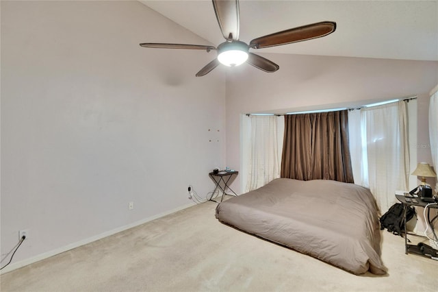 bedroom featuring ceiling fan, baseboards, vaulted ceiling, and carpet flooring