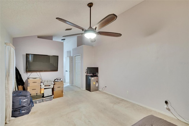 living room with carpet, visible vents, vaulted ceiling, a textured ceiling, and ceiling fan