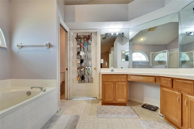 full bathroom featuring a shower with door, tile patterned floors, a garden tub, a spacious closet, and vanity