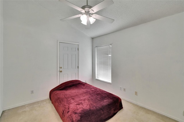 bedroom featuring lofted ceiling, light colored carpet, a ceiling fan, a textured ceiling, and baseboards