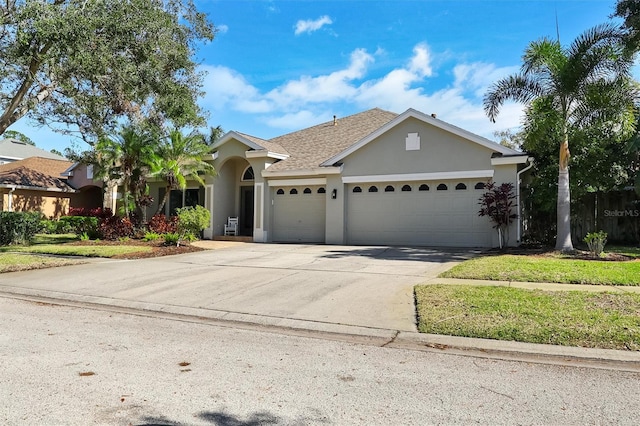 single story home featuring concrete driveway, roof with shingles, an attached garage, and stucco siding