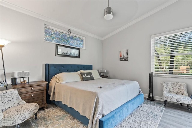 bedroom featuring crown molding, wood finished floors, and baseboards