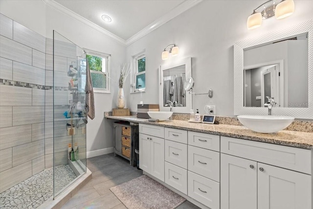 bathroom with a sink, double vanity, ornamental molding, and a shower stall