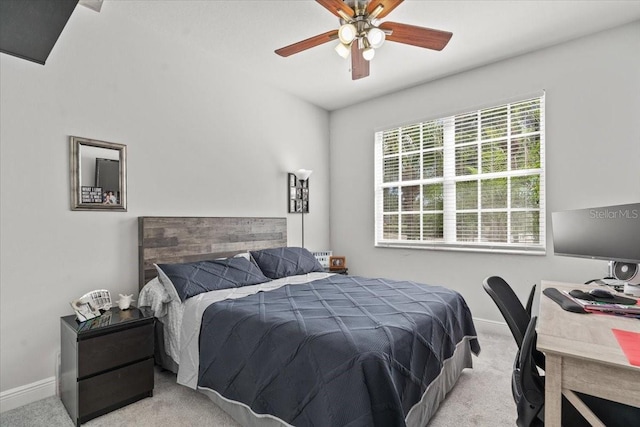 carpeted bedroom featuring baseboards and ceiling fan