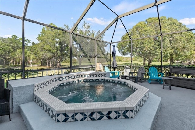 view of swimming pool with a lanai, a patio area, and an outdoor hot tub