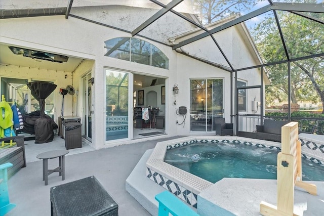 view of pool featuring a hot tub, a lanai, and a patio area