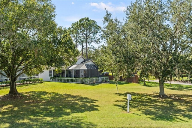 view of home's community featuring a lawn and fence