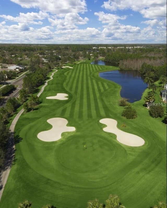 bird's eye view featuring a water view and view of golf course