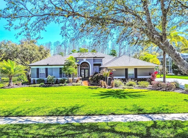 view of front of house with a front lawn and stucco siding