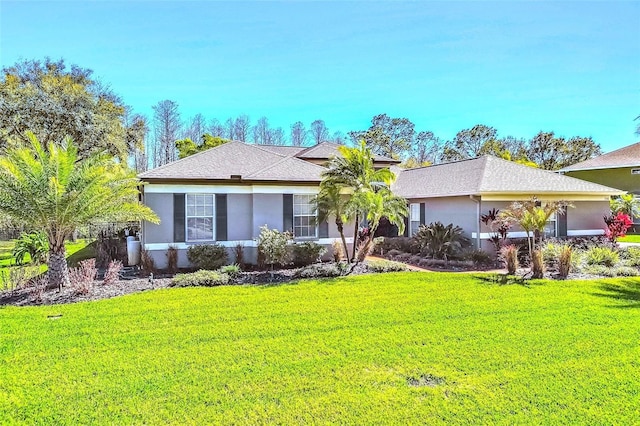 single story home with a garage, stucco siding, and a front yard