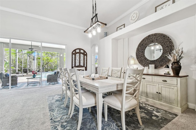 dining area featuring carpet floors, baseboards, arched walkways, and ornamental molding