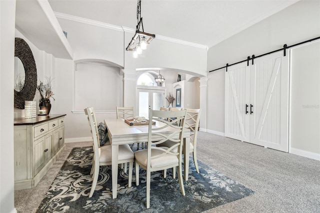 dining room featuring ornate columns, arched walkways, ornamental molding, and light colored carpet