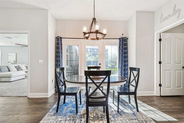 dining room featuring baseboards, dark wood finished floors, and a notable chandelier