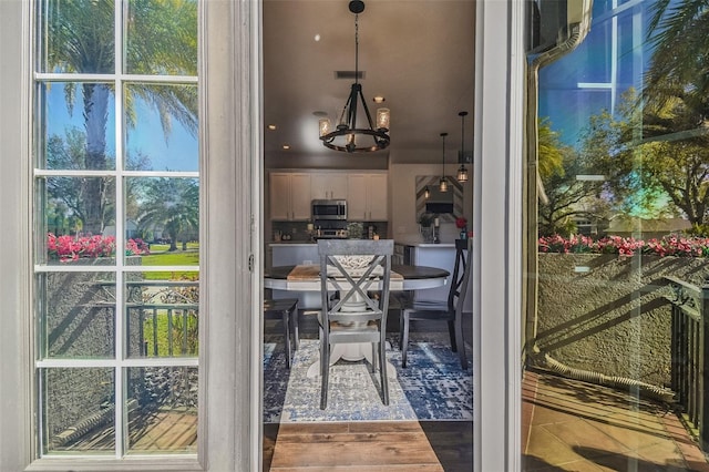 doorway to outside featuring visible vents and wood finished floors