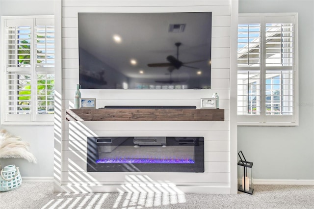 details featuring carpet floors, visible vents, baseboards, and a ceiling fan