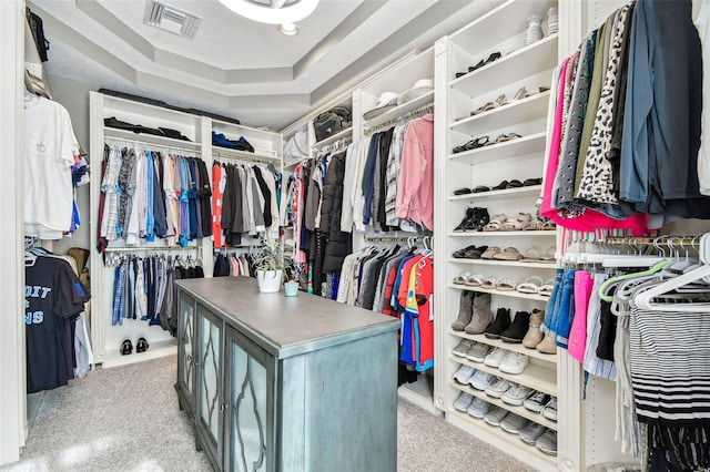 spacious closet featuring a raised ceiling and visible vents