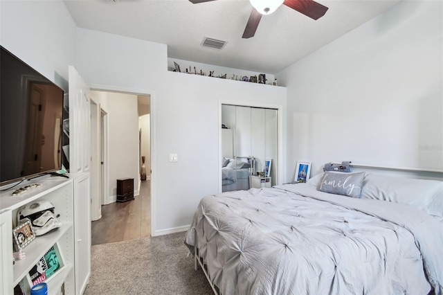 carpeted bedroom with ceiling fan, a closet, visible vents, and baseboards