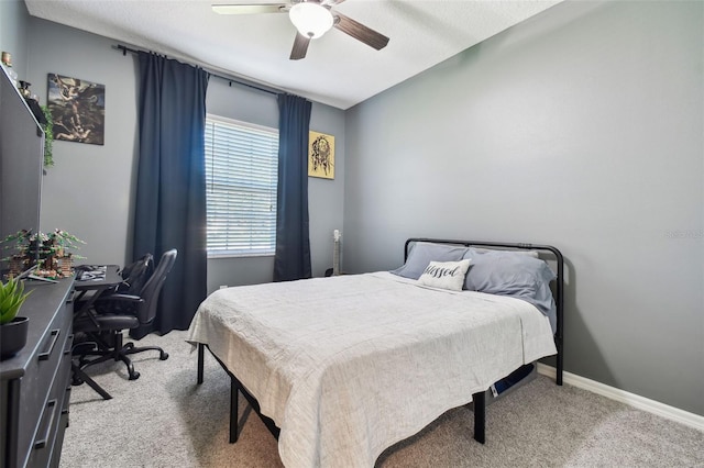 carpeted bedroom featuring a ceiling fan and baseboards