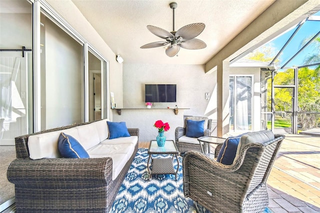 sunroom / solarium featuring ceiling fan