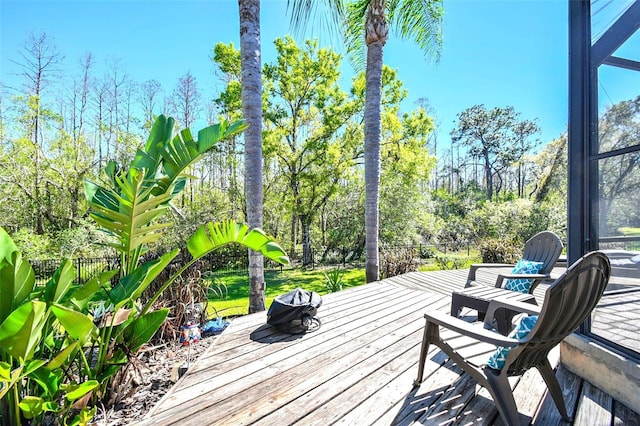 deck with a lanai and fence