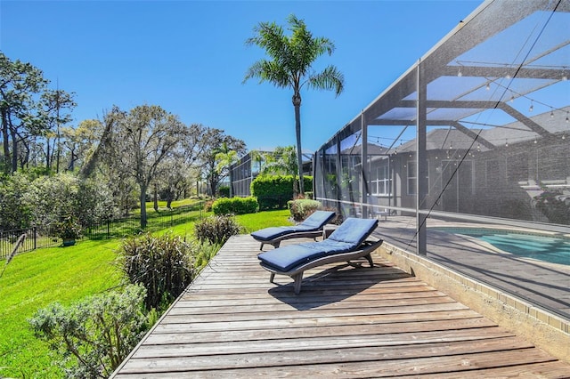 wooden deck featuring a yard, an outdoor pool, fence, and a lanai