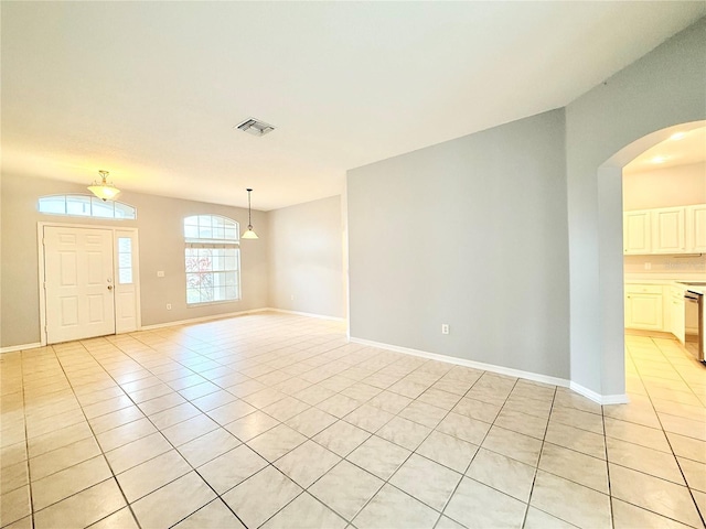 interior space with visible vents, baseboards, and light tile patterned floors