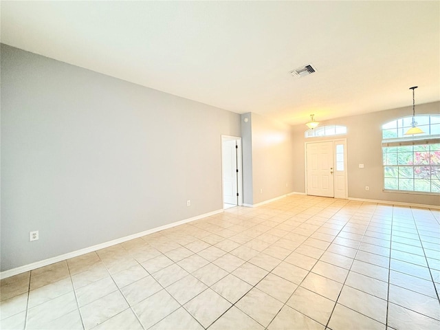 unfurnished room with visible vents, baseboards, and light tile patterned floors