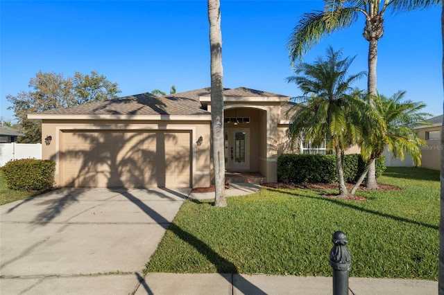 view of front facade with stucco siding, concrete driveway, fence, a garage, and a front lawn