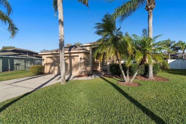 view of front facade with an attached garage, a front lawn, concrete driveway, and stucco siding