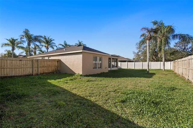 view of yard with a fenced backyard