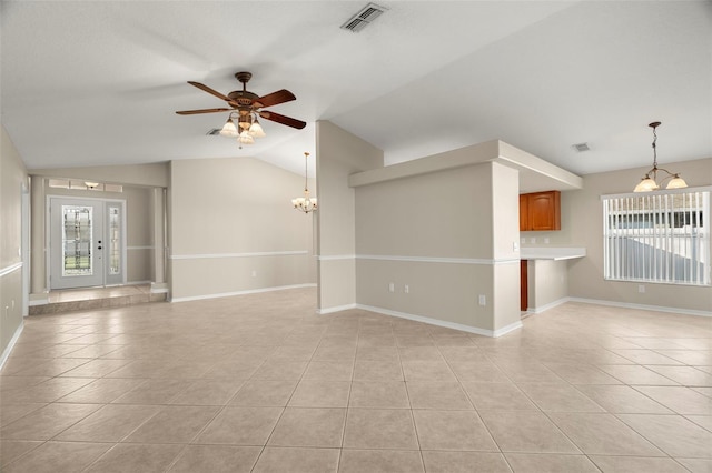 unfurnished living room with light tile patterned floors, baseboards, visible vents, vaulted ceiling, and ceiling fan with notable chandelier